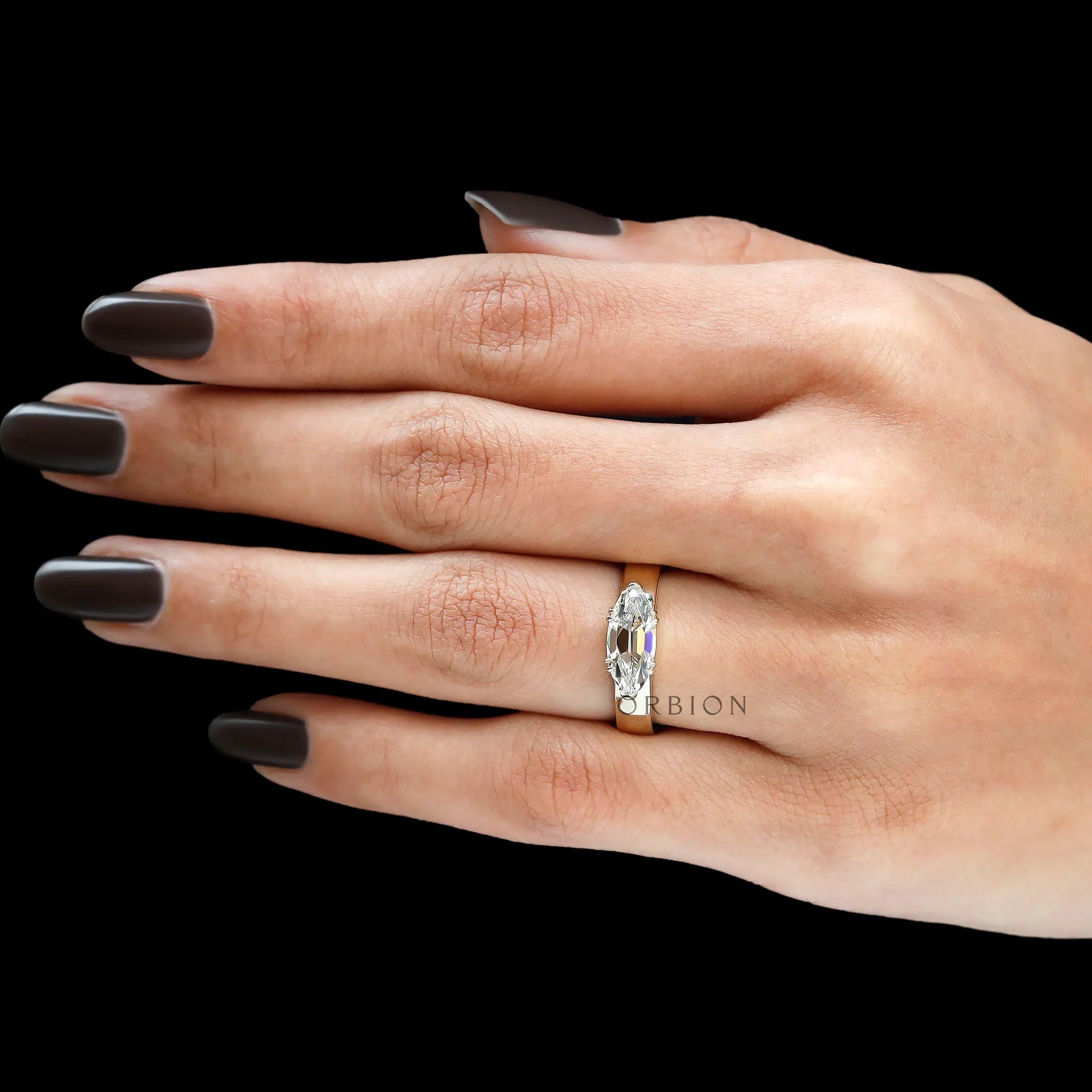 Antique inspired east west engagement ring worn on hand