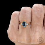 Half bezel setting detail on blue moissanite engagement ring