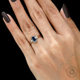 Half bezel set blue moissanite trilogy engagement ring on hand