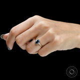 Elegant three stone colored moissanite engagement ring on finger
