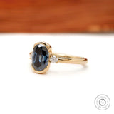 Side profile of half bezel three stone engagement ring