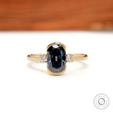 Three stone elongated cushion blue moissanite engagement ring in yellow gold