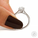 Oval cut hidden halo cathedral engagement ring in white gold