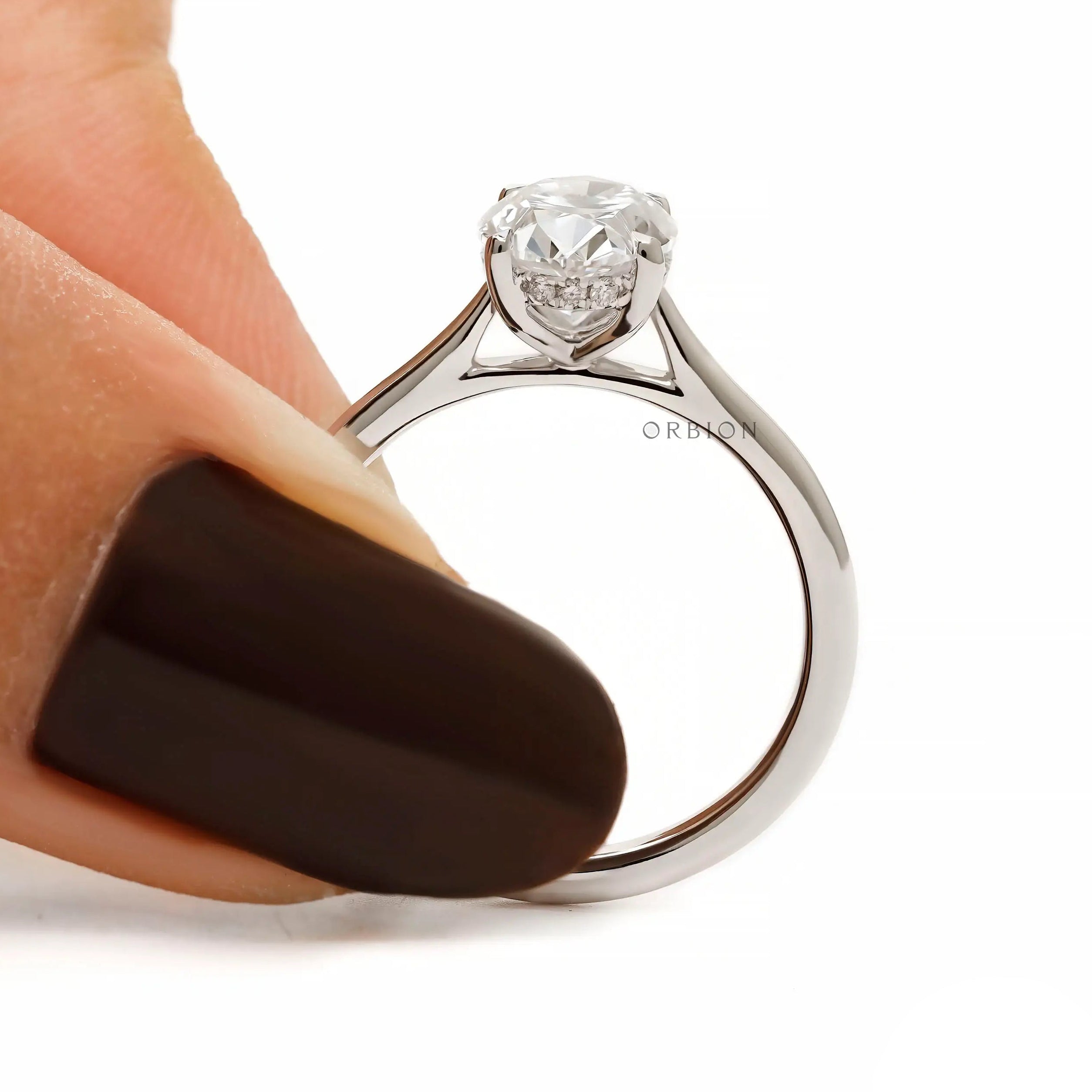 Oval cut hidden halo cathedral engagement ring in white gold