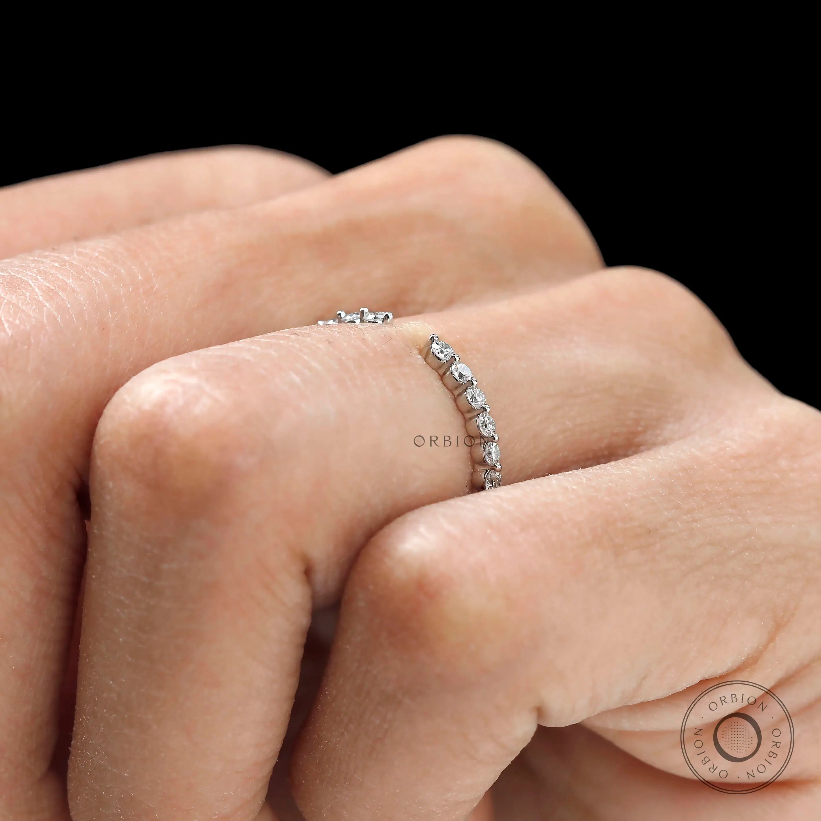 Delicate shared prong round diamond band