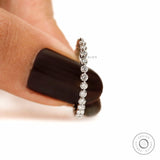 Delicate shared prong round diamond band