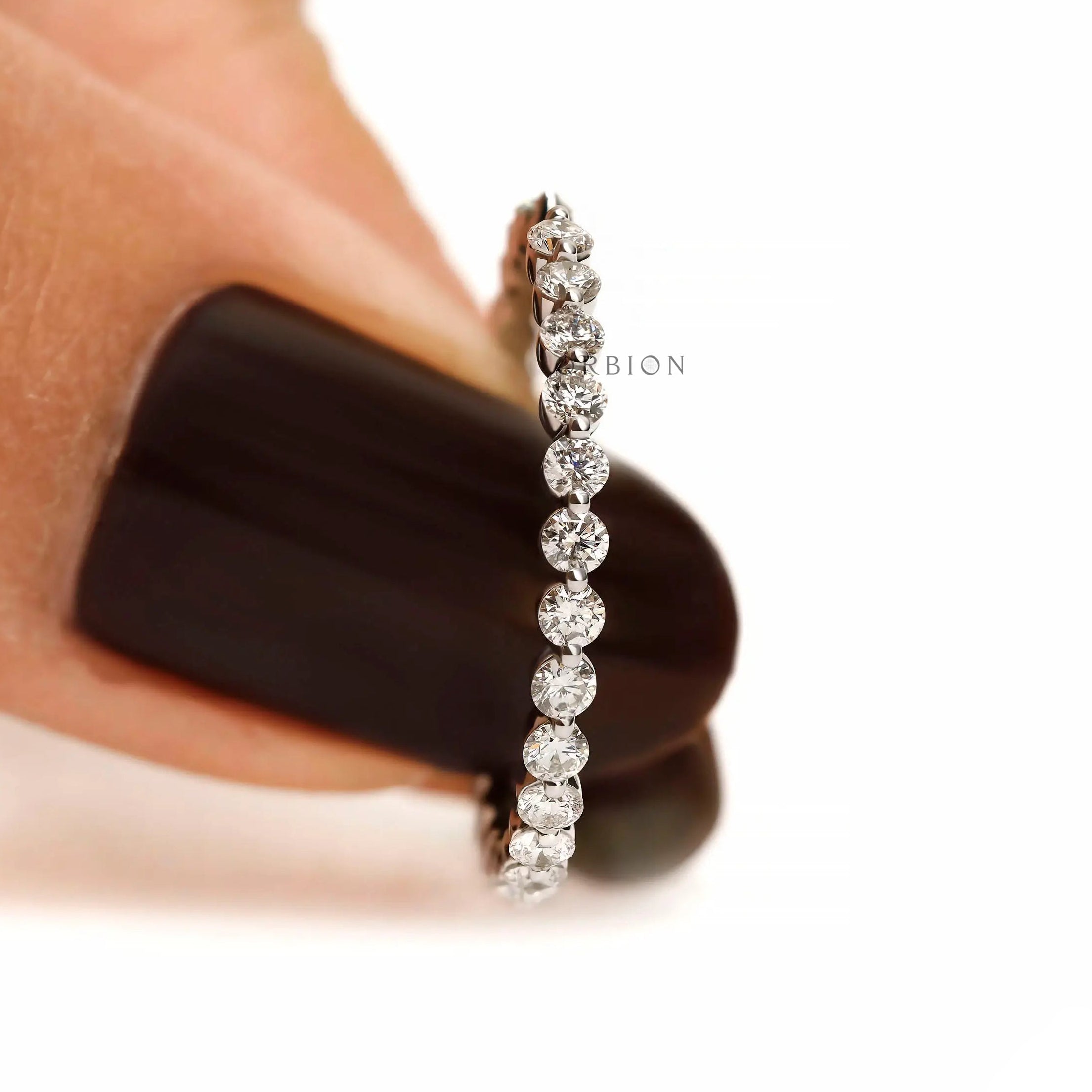 Delicate shared prong round diamond band