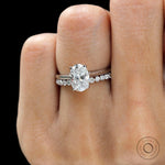 Oval lab grown diamond hidden halo cathedral engagement ring in white gold close up