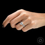 Minimalist open wedding band paired with oval ring