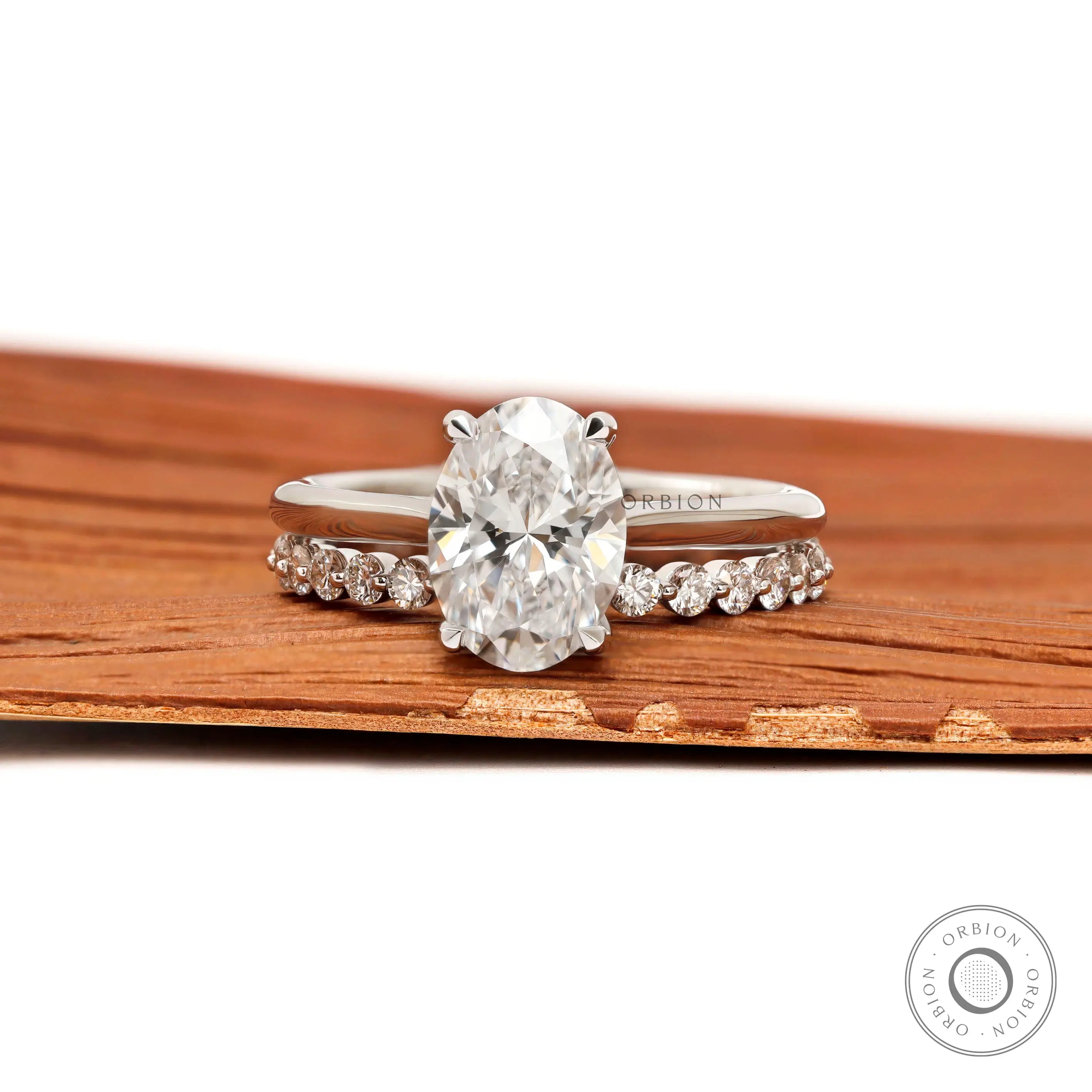 Oval cut hidden halo cathedral engagement ring in white gold