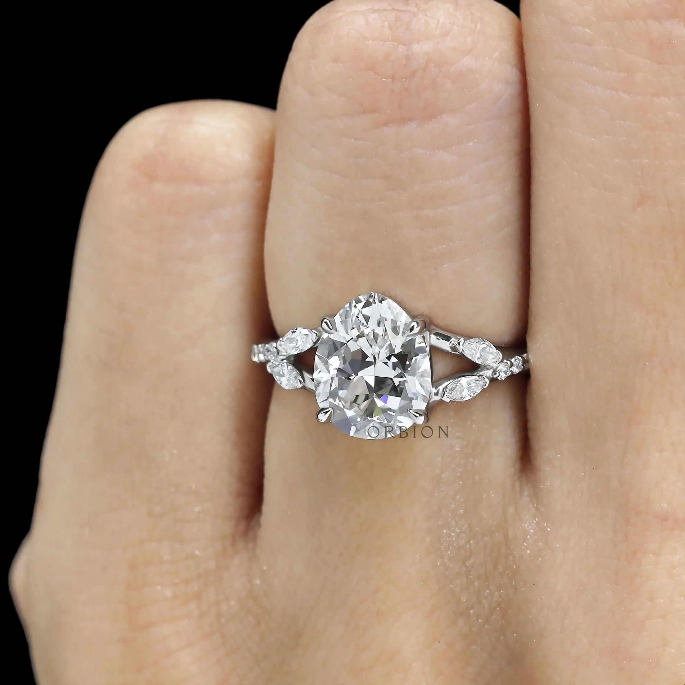 Platinum engagement ring featuring pear-shaped lab diamond, split shank