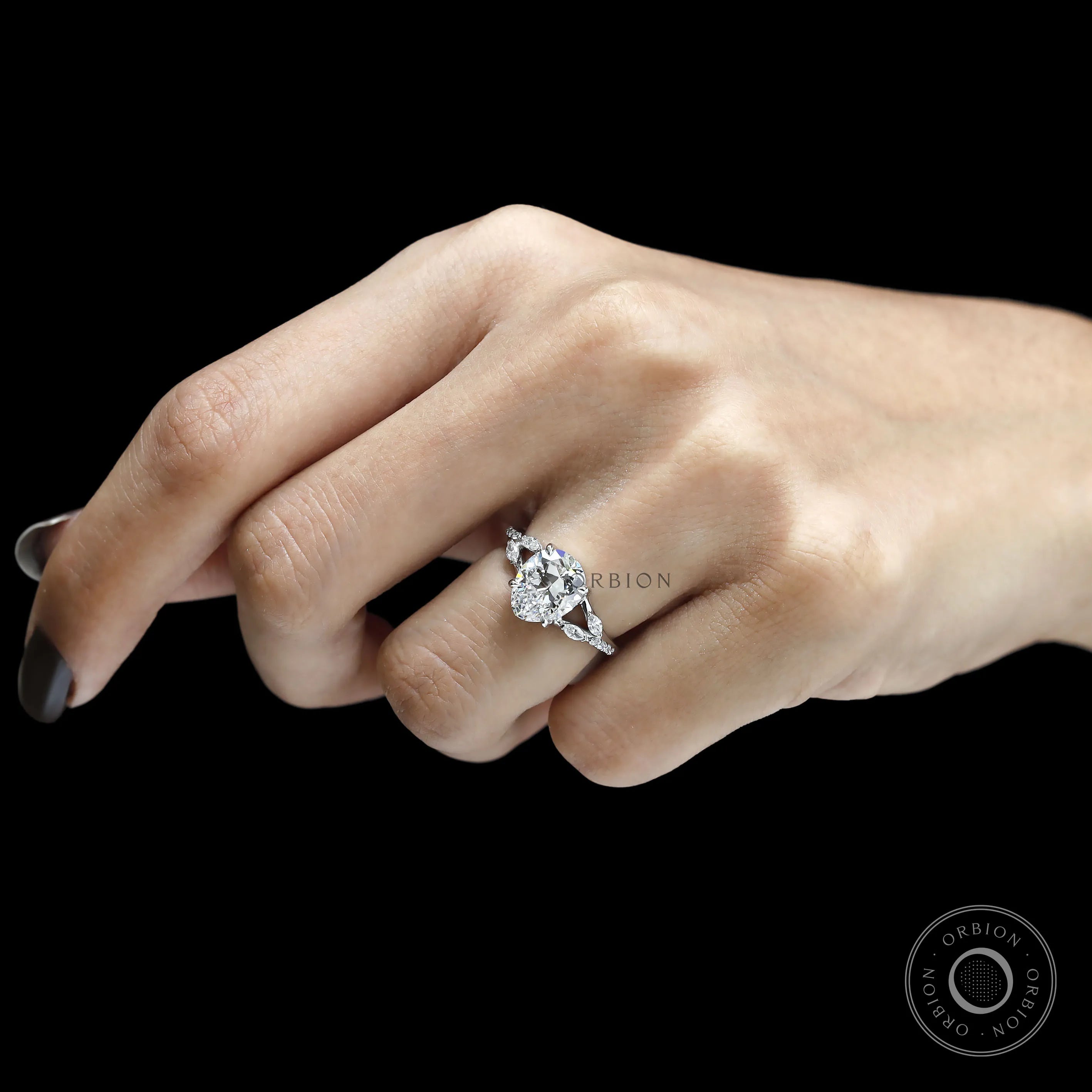 Pear-shaped moissanite platinum engagement ring with split shank and mixed marquise and round stones