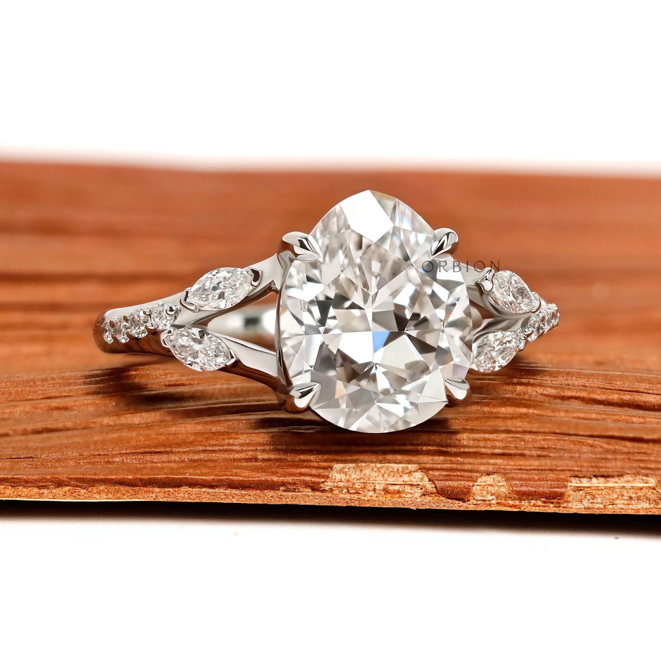 Fat pear lab grown diamond platinum engagement ring with split shank and marquise and round accents