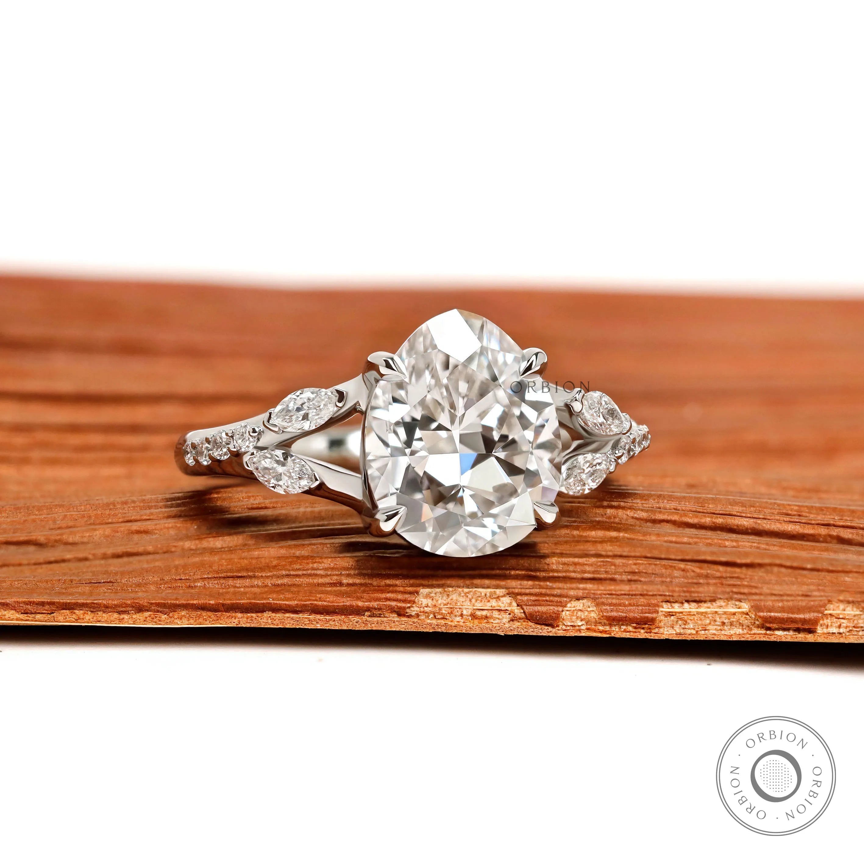 Fat pear lab grown diamond platinum engagement ring with split shank and marquise and round accents