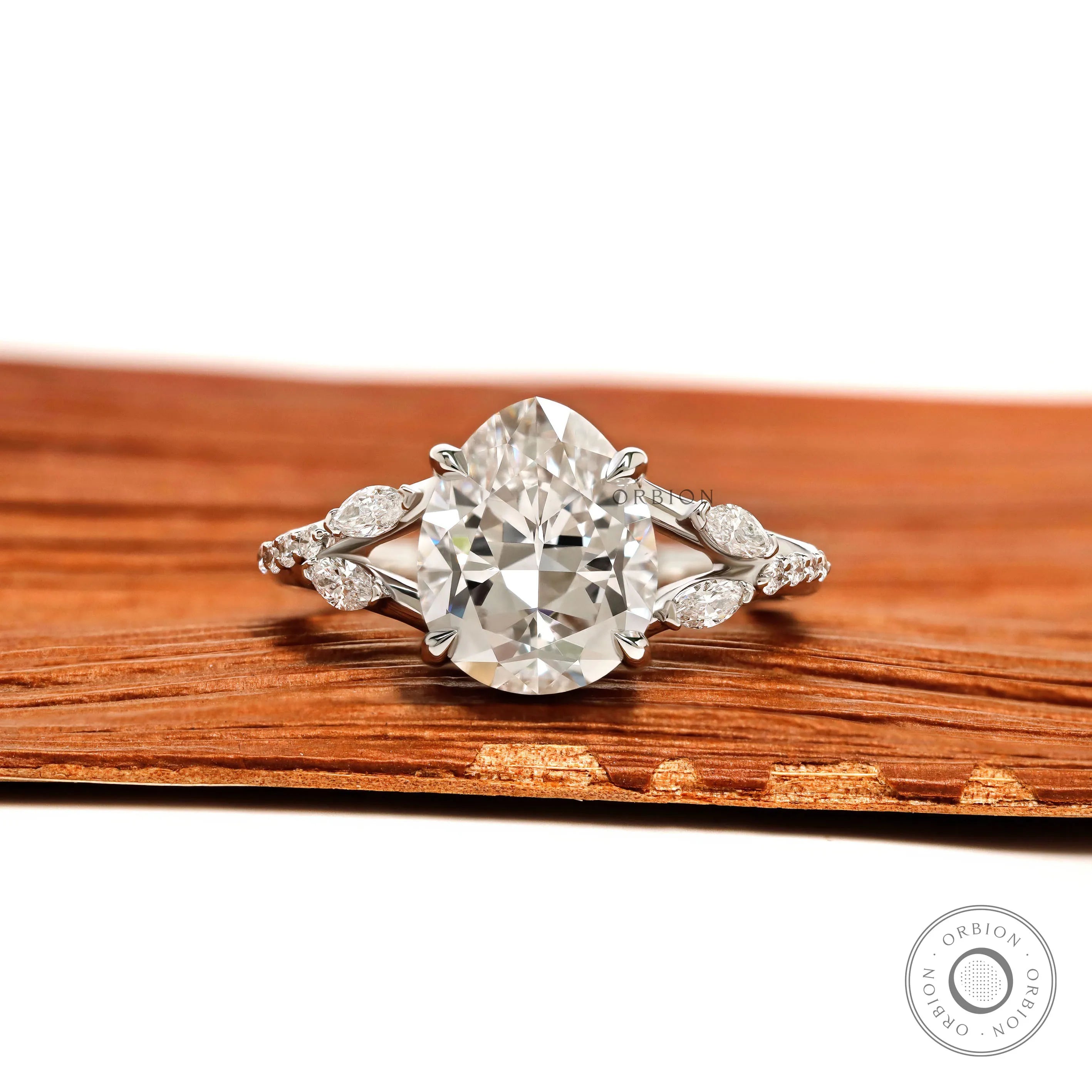 Platinum engagement ring featuring fat pear lab diamond, split shank, marquise and round accent stones
