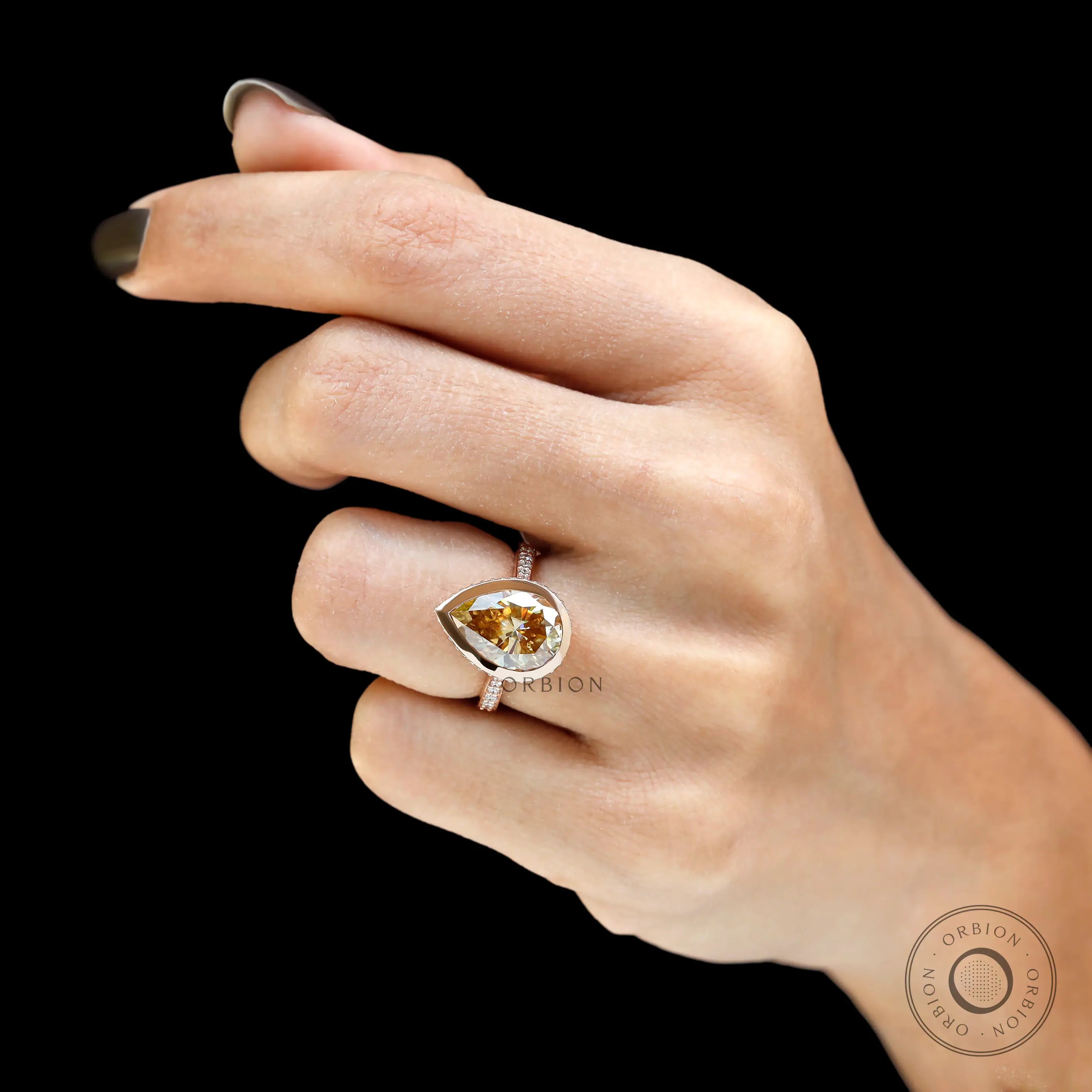 Pear shaped champagne moissanite bezel halo ring