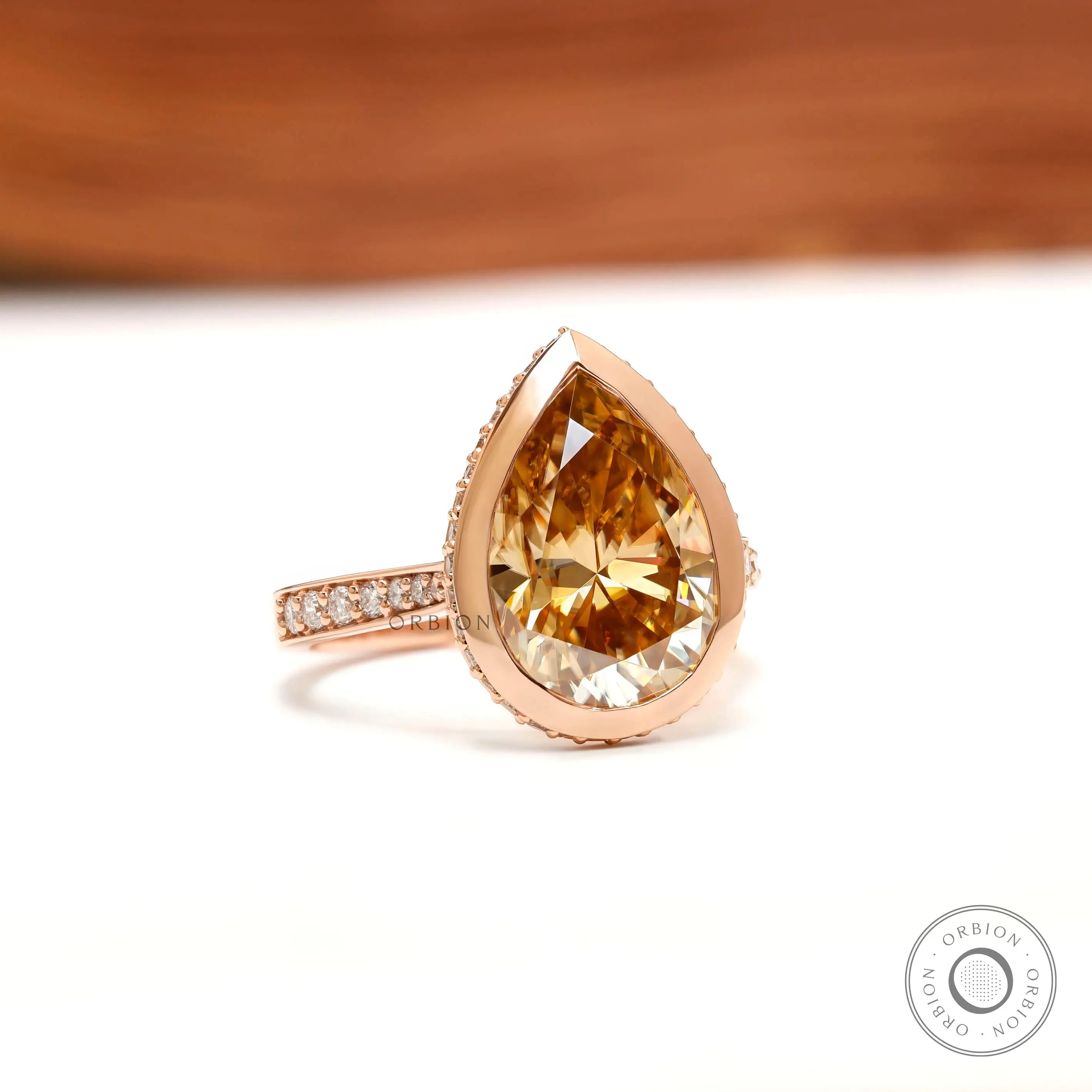 Pear light champagne moissanite pave bezel halo engagement ring in 14k rose gold