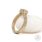 Starburst cushion moissanite engagement ring in brushed yellow gold