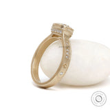 Starburst cushion moissanite engagement ring in brushed yellow gold