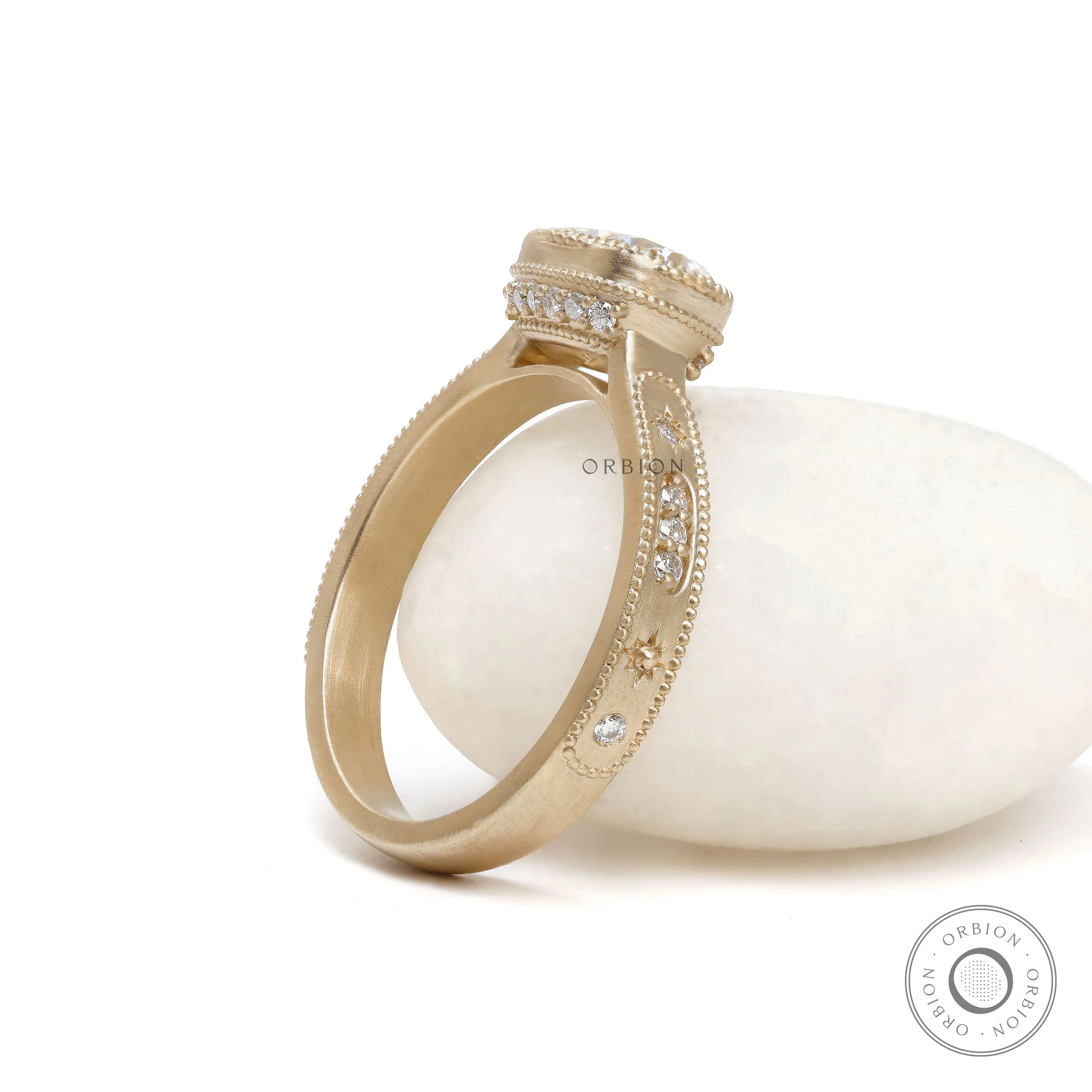 Starburst cushion moissanite engagement ring in brushed yellow gold