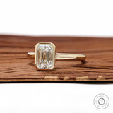 Modern emerald cut lab diamond bezel ring in yellow gold