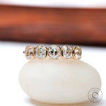 Five elongated cushion moissanites bezel set in rose gold band