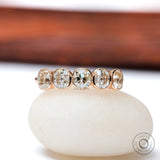 Five elongated cushion moissanites bezel set in rose gold band