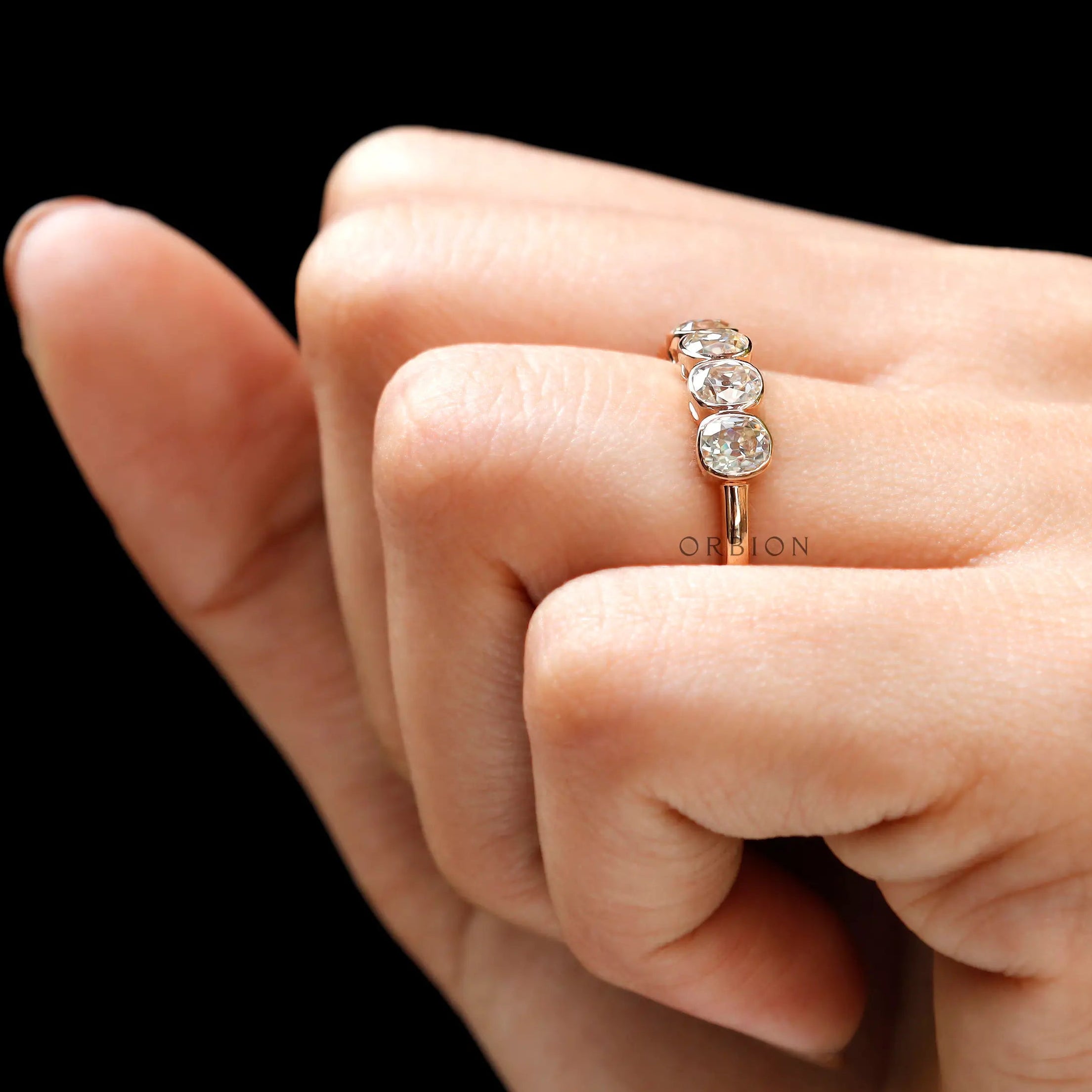 Five stone moissanite half eternity band on hand front view