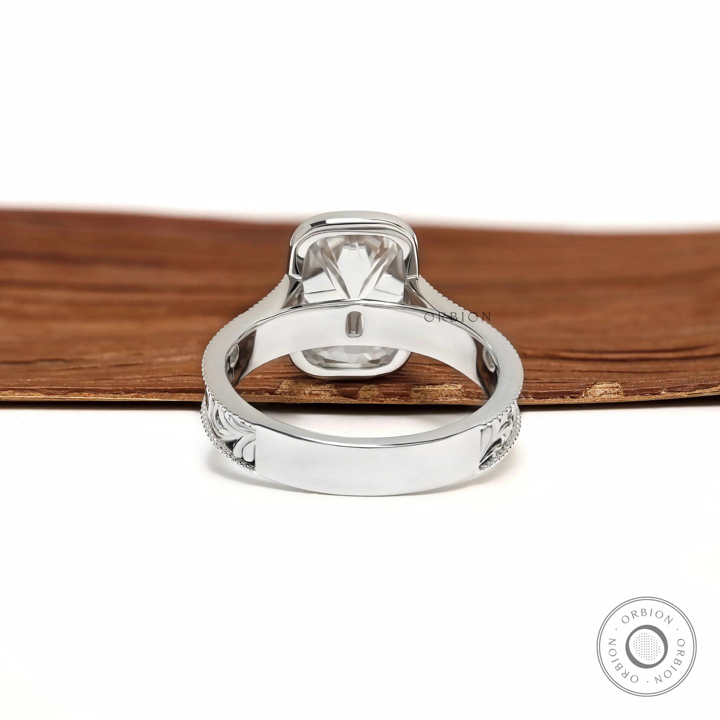 Ornate scrollwork ring with milgrain bezel and cushion moissanite stone