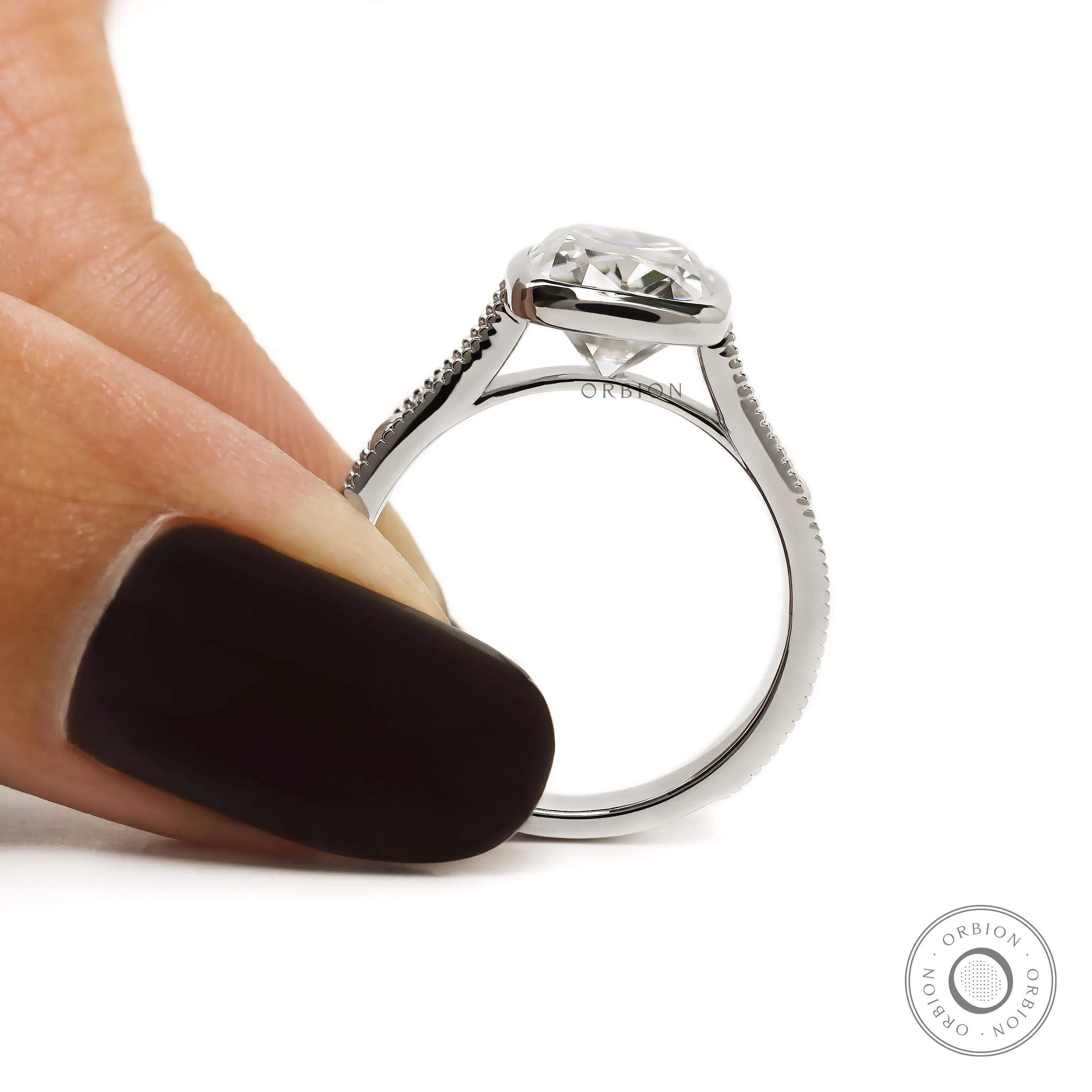Cathedral setting ring with engraved details and bezel set cushion diamond