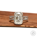 Engraved bezel set elongated cushion moissanite ring thick white gold band