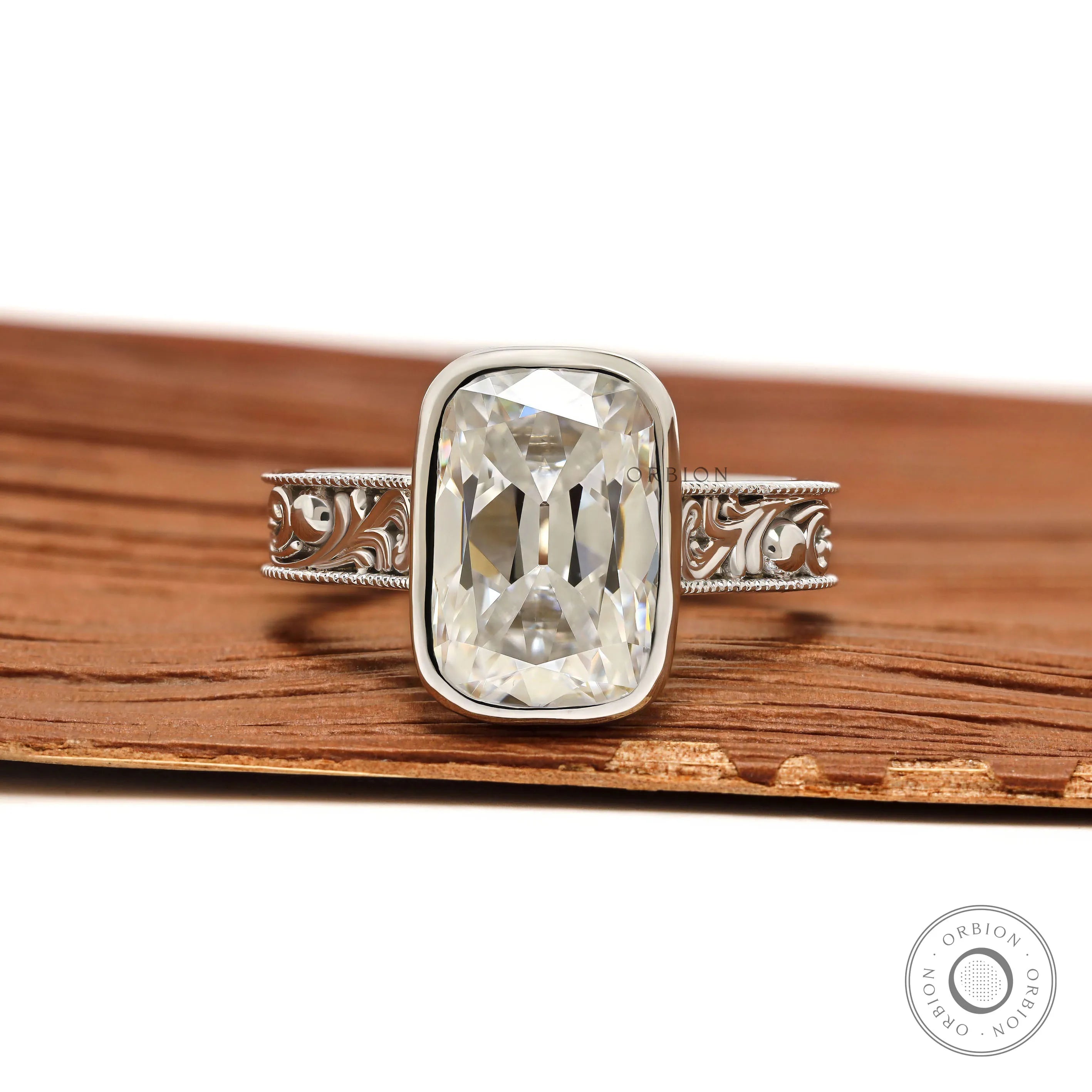 Engraved bezel set elongated cushion moissanite ring thick white gold band