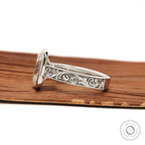 Antique style engagement ring with scroll engraving and cushion center stone