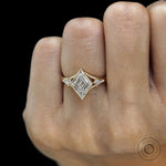 Stylish yellow gold three stone engagement ring with lozenge moissanite and kite side stones
