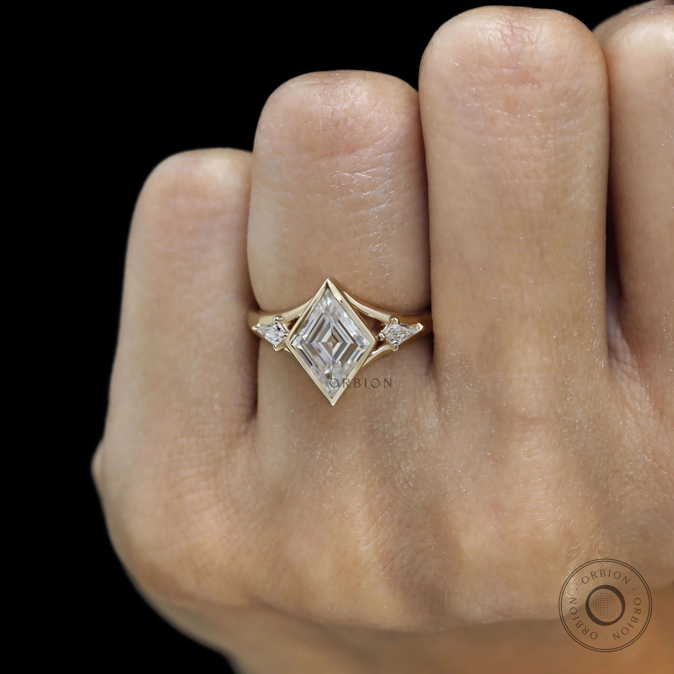 Stylish yellow gold three stone engagement ring with lozenge moissanite and kite side stones