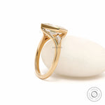 Three stone engagement ring featuring lozenge cut moissanite and kite shaped accents