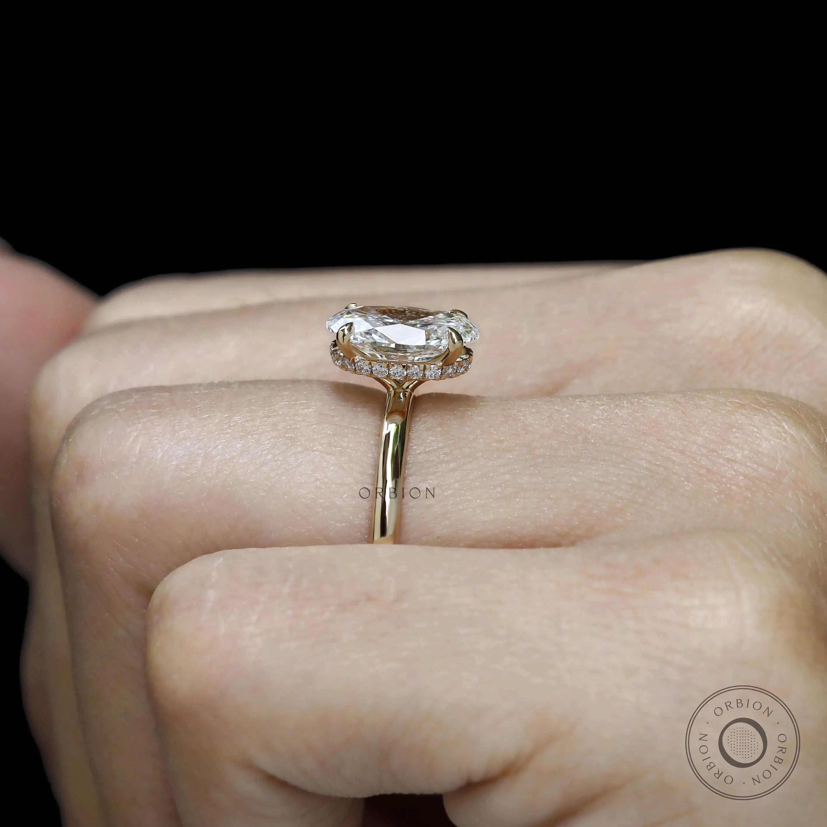 Oval cut lab diamond with hidden halo in 18k yellow gold engagement ring