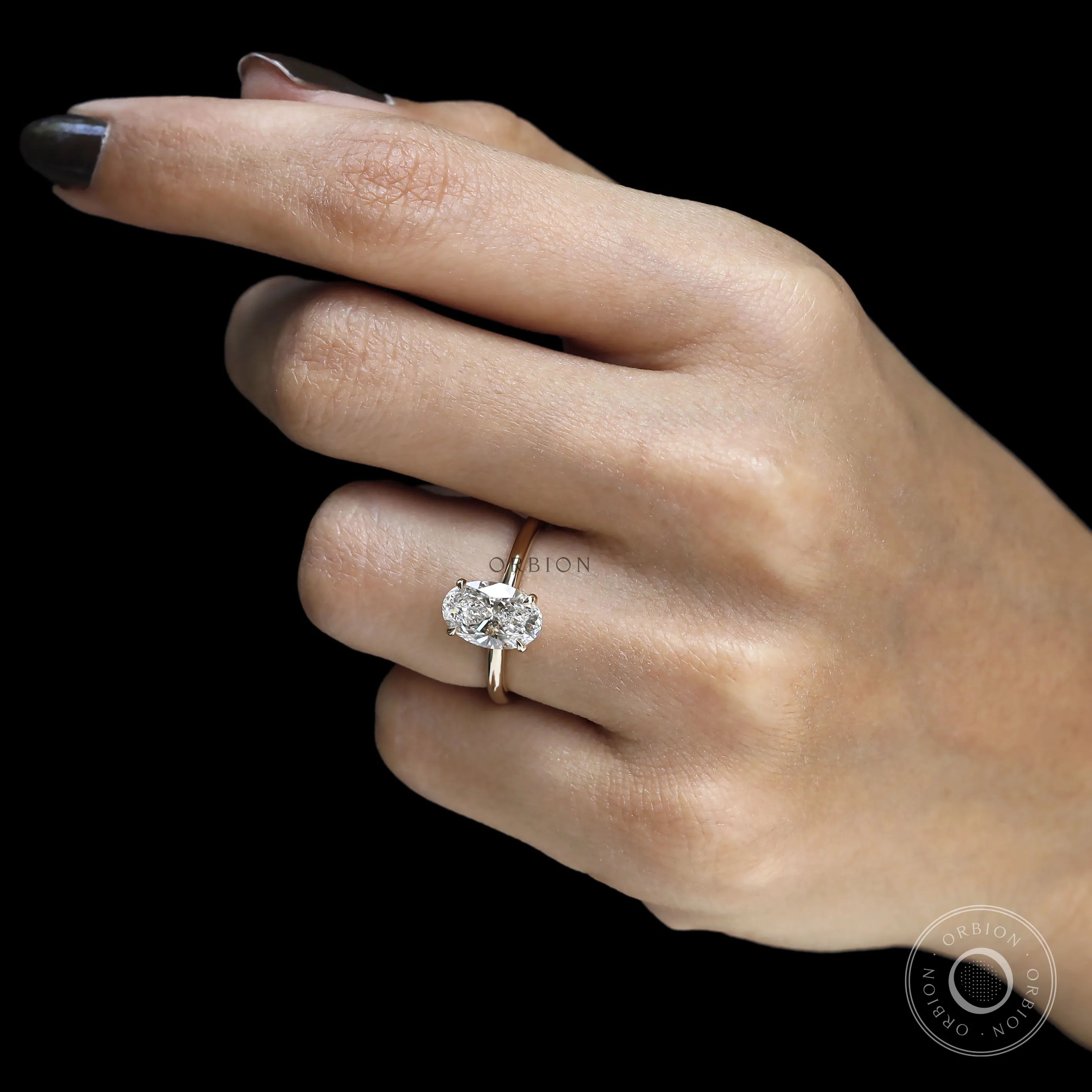2 Carat oval shaped lab grown diamond engagement ring with hidden halo and yellow gold band