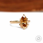 18k yellow gold cathedral ring featuring pear dark champagne moissanite and tulip floral setting