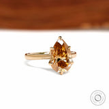 18k yellow gold cathedral ring featuring pear dark champagne moissanite and tulip floral setting