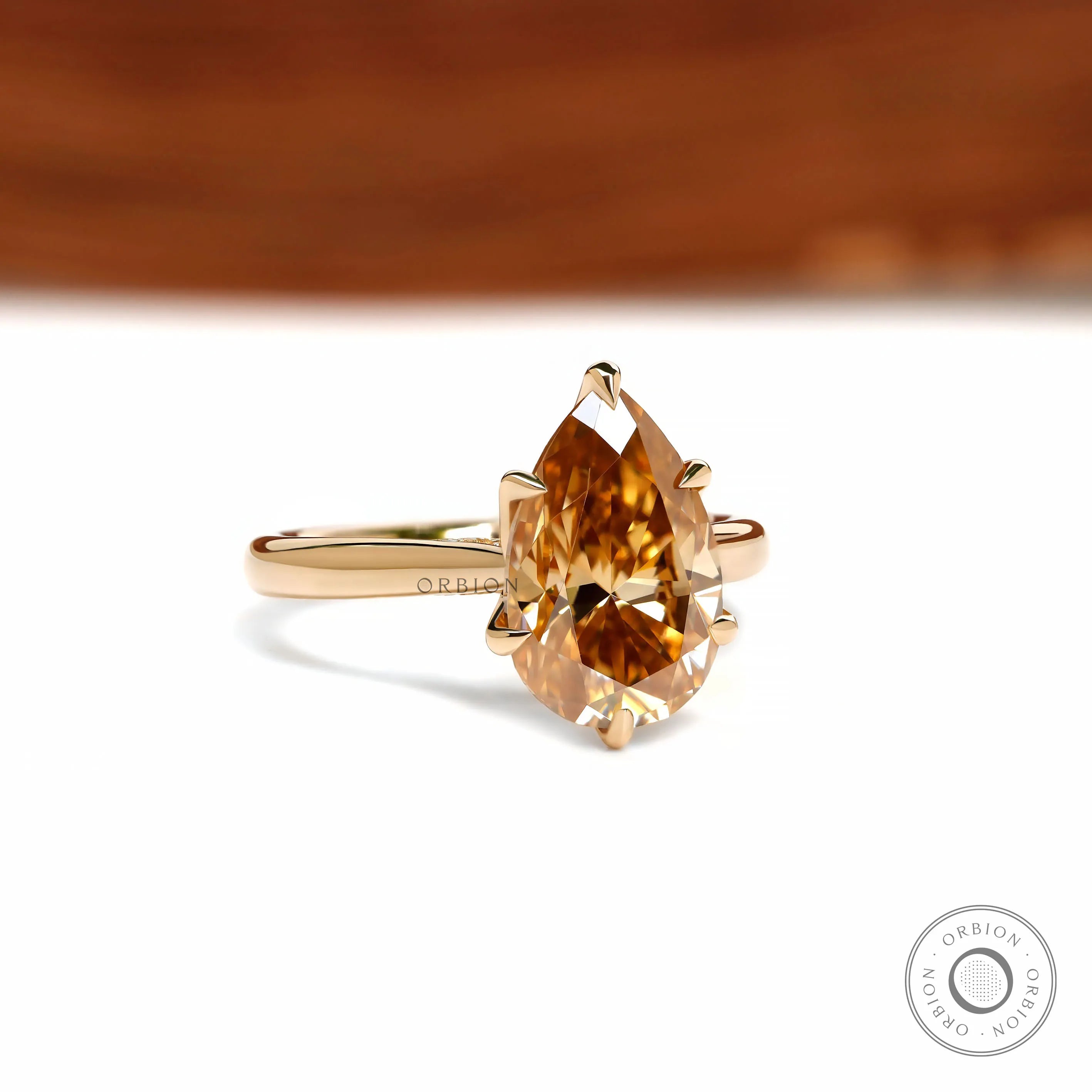 18k yellow gold cathedral ring featuring pear dark champagne moissanite and tulip floral setting