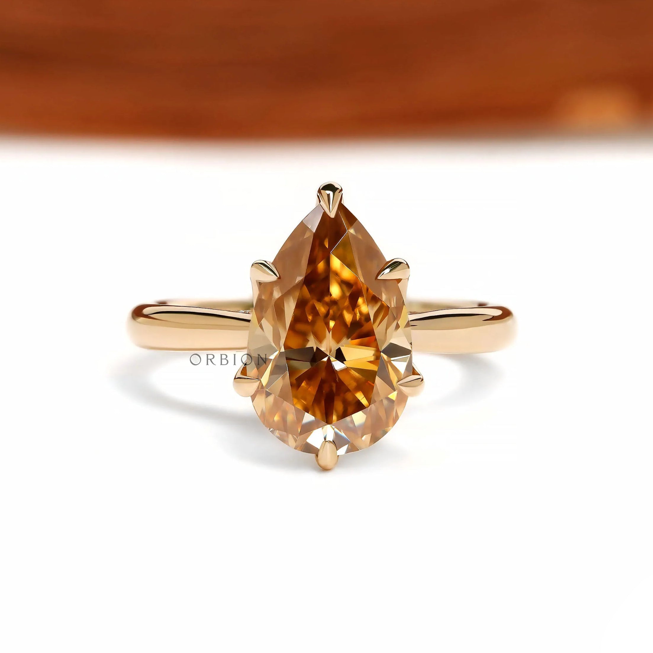 Tulip set pear dark champagne moissanite ring with floral bridge design in 18k yellow gold
