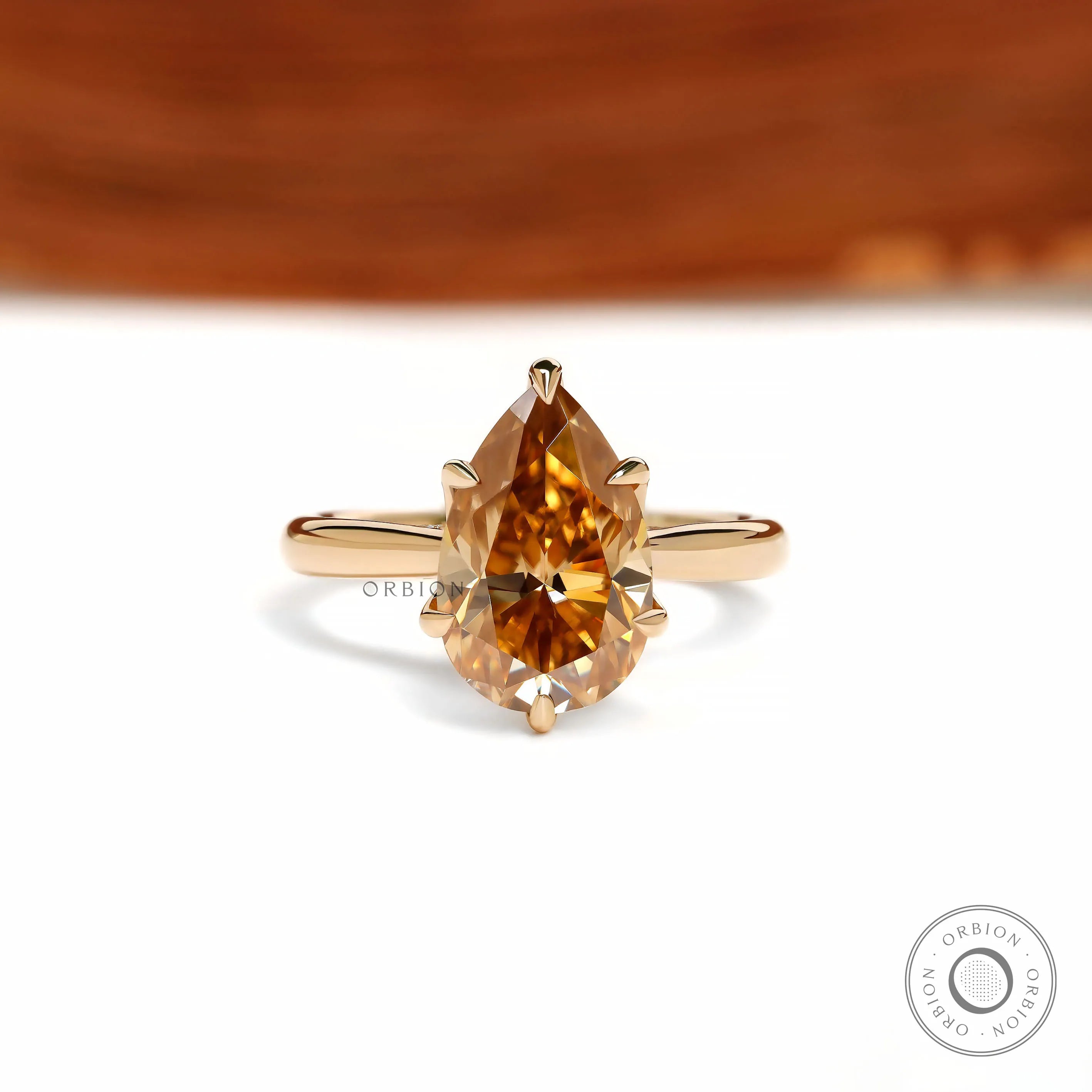 Tulip set pear dark champagne moissanite ring with floral bridge design in 18k yellow gold
