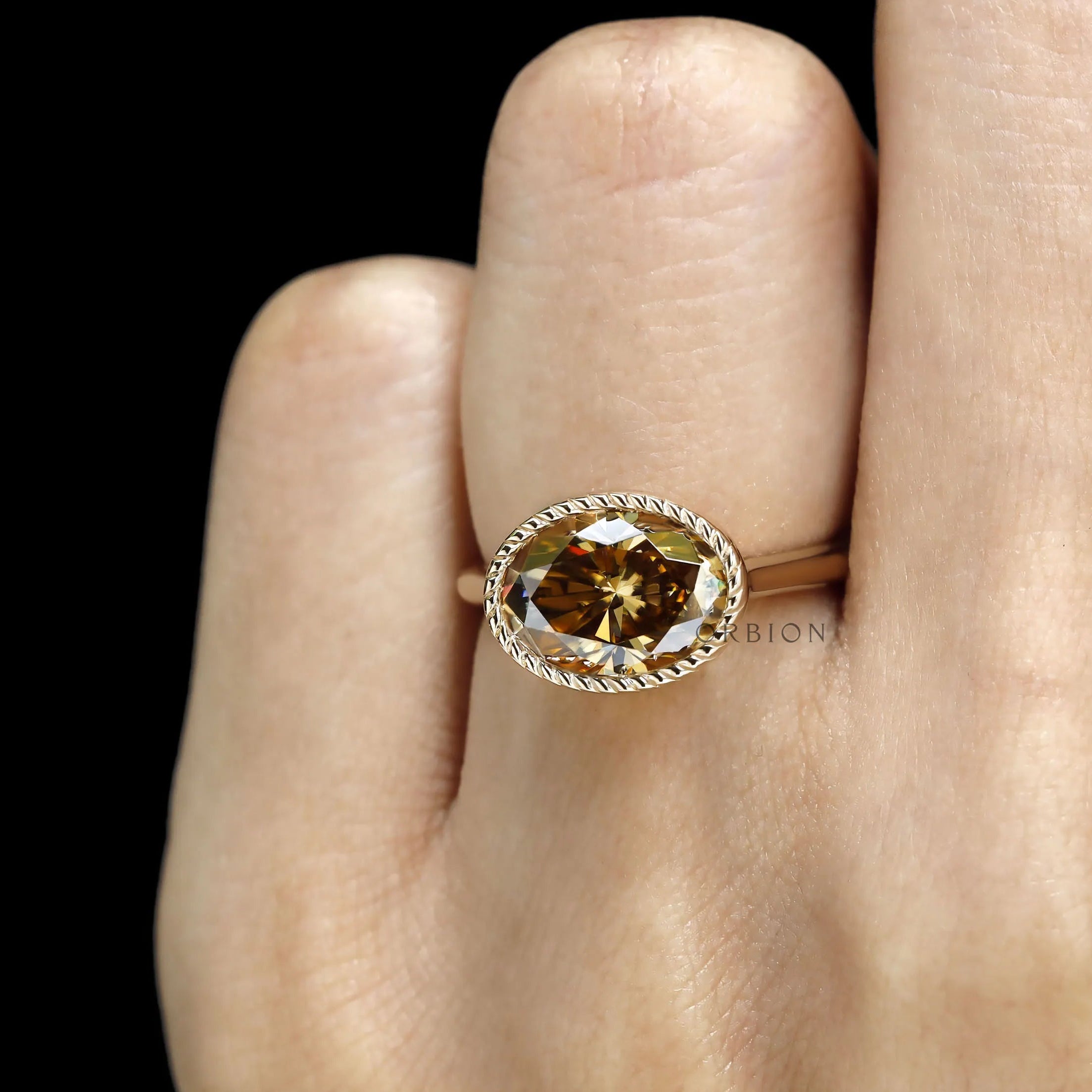 18k yellow gold East West oval dark champagne moissanite ring, tulip set, cathedral style