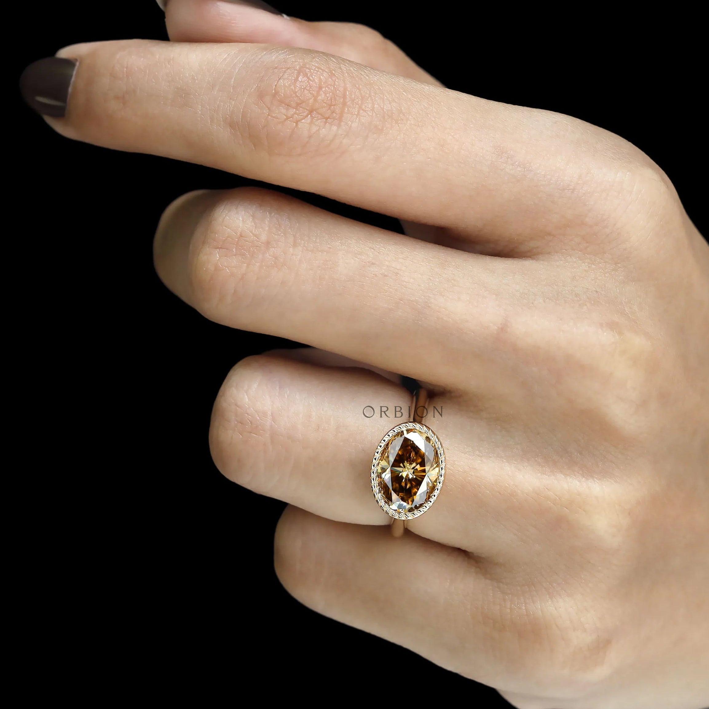 East West oval dark champagne moissanite cocktail ring with rope bezel and tulip setting, cathedral band