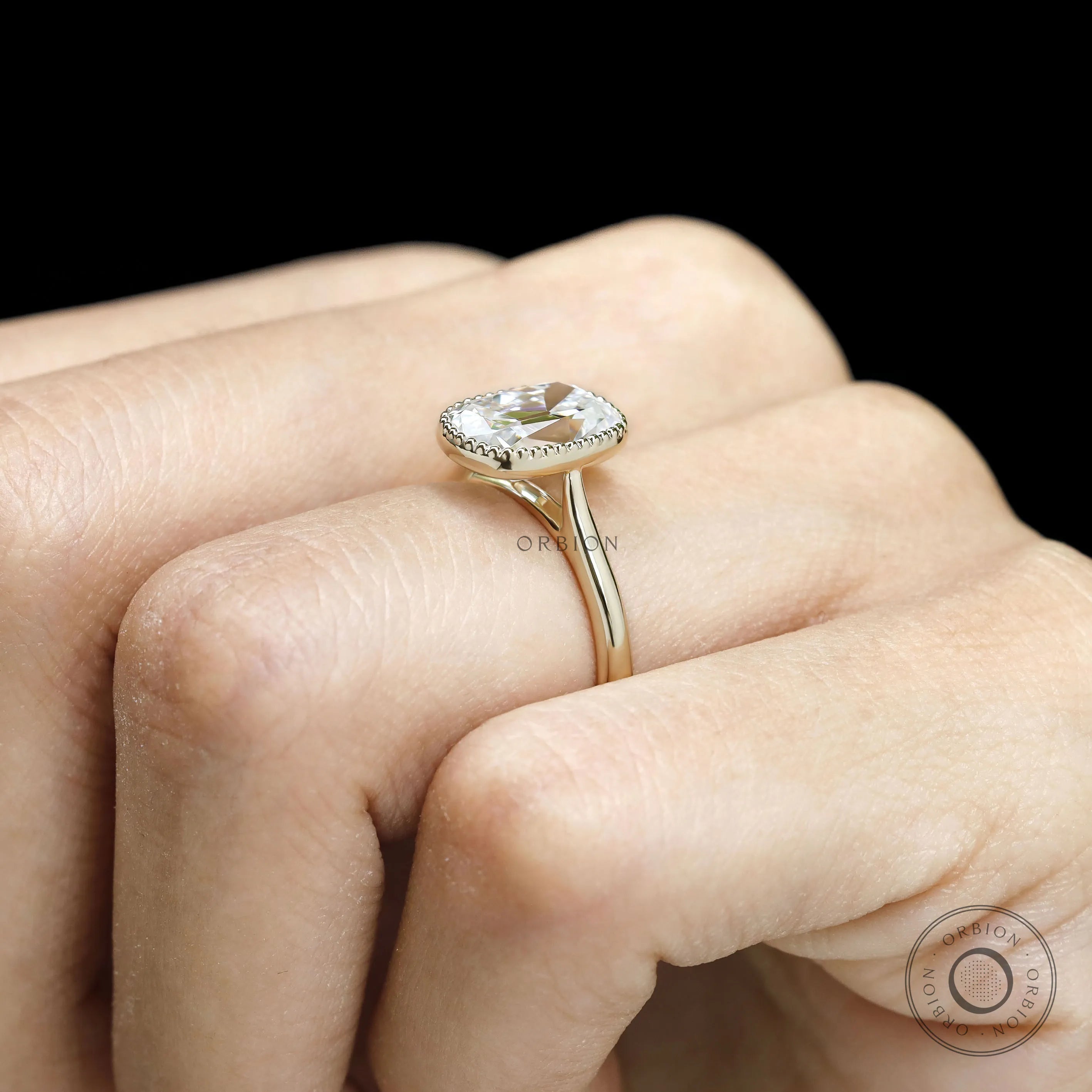10k yellow gold cathedral engagement ring featuring elongated cushion OMC moissanite with milgrain bezel