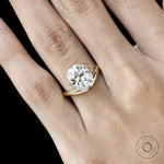 Compass set elongated cushion solitaire ring yellow gold curved band. 