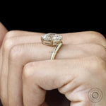 Fine jewelry yellow gold ring featuring curved elongated cushion lab diamond, bypass design