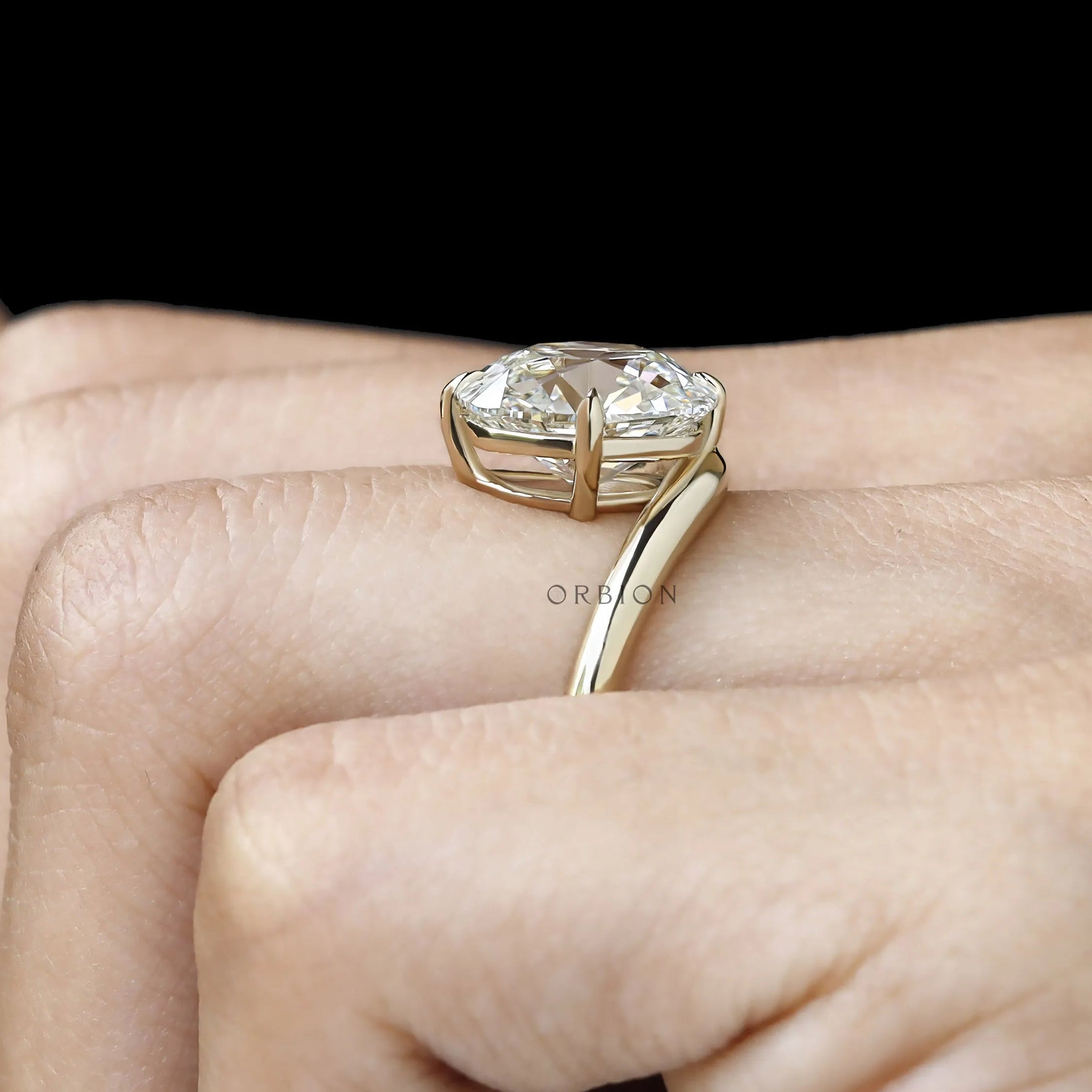 Fine jewelry yellow gold ring featuring curved elongated cushion lab diamond, bypass design