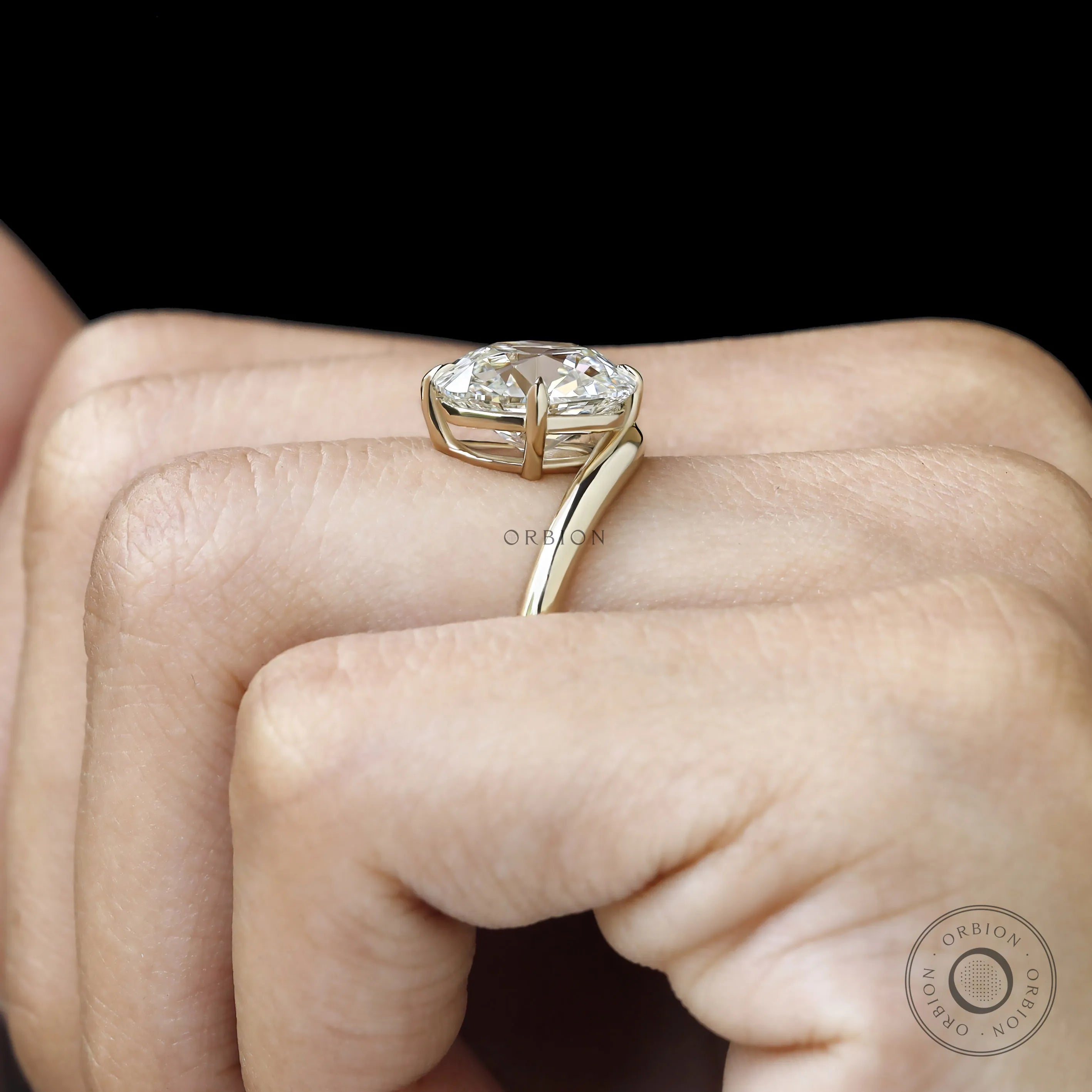 Fine jewelry yellow gold ring featuring curved elongated cushion lab diamond, bypass design